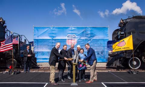 Tapping a ceremonial Golden Spike from left are Sandy Dodge, descendent of Gen. Grenville Dodge; Utah Gov. Gary Herbert, Union Pacific Chairman, President and CEO Lance Fritz, Utah Congressman Rob Bishop, Margarat Yee, a descendent of a Central Pacific employee, and Scott Moore, Union Pacific senior vice president-Corporate Relations and chief administrative officer.